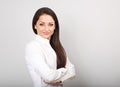 Beautiful business calm confident woman in white shirt looking with folded arms on blue background Royalty Free Stock Photo