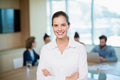 Beautiful business executive standing with her arms crossed in office Royalty Free Stock Photo