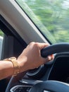 indian young woman driving a car suv in the mountain road a rainy cloudy day