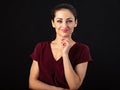 Beautiful business thinking enjoying smiling woman with long brown healthy hair and pink lipstick in dark red shirt clothing. Royalty Free Stock Photo