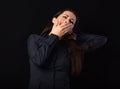 Beautiful business tired woman want to sleep and yawning in blue shirt isolated on black background with empty copy space. Closeup Royalty Free Stock Photo