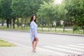 A beautiful business woman in a blue long shirt crosses the road Royalty Free Stock Photo