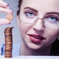 Beautiful business woman with column coins as symbol of investment or growth.(Money, wealth, entrepreneurship, discount, savings Royalty Free Stock Photo