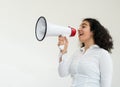 Beautiful business woman with curly hair holding a megaphone