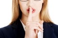 Beautiful business woman with finger on lips. Royalty Free Stock Photo