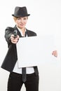 Beautiful business woman with gun olding a blank billboard. Royalty Free Stock Photo