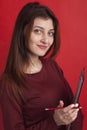 Beautiful business woman holding document folder on red background Royalty Free Stock Photo