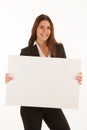 Beautiful business woman holds blank banner isolated over white background