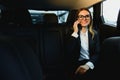 Beautiful business woman sitting on back seat in the car Royalty Free Stock Photo