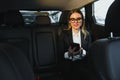 Beautiful business woman sitting on back seat in the car Royalty Free Stock Photo