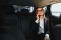 Beautiful business woman sitting on back seat in the car Royalty Free Stock Photo