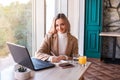 Beautiful business woman sitting in cafe and taking notes in notebook. Royalty Free Stock Photo