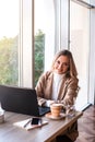 Beautiful business woman sitting in cafe and taking notes in notebook. Royalty Free Stock Photo