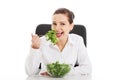 Beautiful business woman sitting and eating lettuce. Royalty Free Stock Photo
