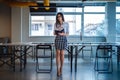 Beautiful business woman sitting on office desk and holding note Royalty Free Stock Photo