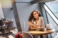 Beautiful business woman with smartphone waiting for her flight in an airport. Royalty Free Stock Photo