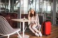 Beautiful business woman with tablet waiting for her flight in an airport. Royalty Free Stock Photo