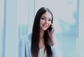 Beautiful business woman talking on cell phone while looking at copyspace. Royalty Free Stock Photo