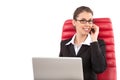 Beautiful business woman talking on mobile phone sitting on a red chair in office Royalty Free Stock Photo