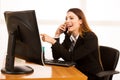 Beautiful business woman talks on smert phone in office at her d Royalty Free Stock Photo