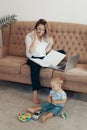 Beautiful business woman working at home. Multi-tasking, freelance and motherhood concept Royalty Free Stock Photo