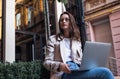 Beautiful business woman working on laptop outside her office Royalty Free Stock Photo