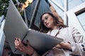 Beautiful business woman working on laptop outside her office Royalty Free Stock Photo