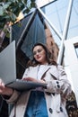 Beautiful business woman working on laptop outside her office Royalty Free Stock Photo