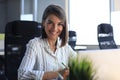 Beautiful business woman is writing something down while sitting in the office desk Royalty Free Stock Photo