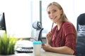 Beautiful business woman is writing something down while sitting at the office desk Royalty Free Stock Photo