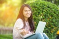 Beautiful business working woman using Iphone Ipad while working with laptop Royalty Free Stock Photo