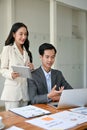 A beautiful businesswoman is briefing work and co-working with a smart male financial analyst Royalty Free Stock Photo