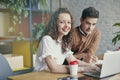 Beautiful businesswoman with curly hair smiling, gathered together with partner, discussing creative idea in office. Royalty Free Stock Photo