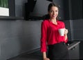 Beautiful businesswoman drinking coffee/tea in a modern kitchen Royalty Free Stock Photo