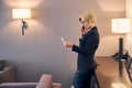 Beautiful businesswoman having phone conversation in hotel room Royalty Free Stock Photo