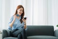 Beautiful businesswoman holding a cup of coffee relaxing happily working through a tablet for a successful business while sitting Royalty Free Stock Photo