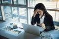 Beautiful businesswoman holding glasses got stress and headache with computer on table Royalty Free Stock Photo