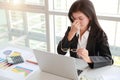 Beautiful businesswoman holding glasses got stress and headache with computer on table Royalty Free Stock Photo