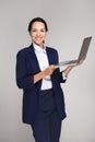 Beautiful businesswoman with laptop on grey background Royalty Free Stock Photo