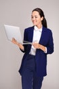 Beautiful businesswoman with laptop on grey background Royalty Free Stock Photo