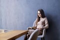 Beautiful businesswoman with long hair reading a book