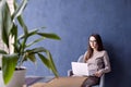 Beautiful businesswoman with long hair using modern laptop computer while sitting in his modern loft office. Royalty Free Stock Photo