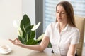 Beautiful businesswoman meditating in office Royalty Free Stock Photo