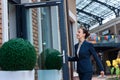 beautiful businesswoman opening door