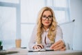 beautiful businesswoman sitting at table