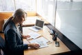 Beautiful businesswoman sitting at the table with laptop and papers Royalty Free Stock Photo