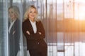 Beautiful businesswoman smiling with folded arms in office. Royalty Free Stock Photo