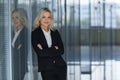 Beautiful businesswoman smiling with folded arms in office. Royalty Free Stock Photo