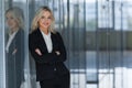 Beautiful businesswoman smiling with folded arms in office. Royalty Free Stock Photo