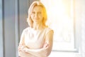 Portrait of beautiful businesswoman standing with arms crossed at office Royalty Free Stock Photo